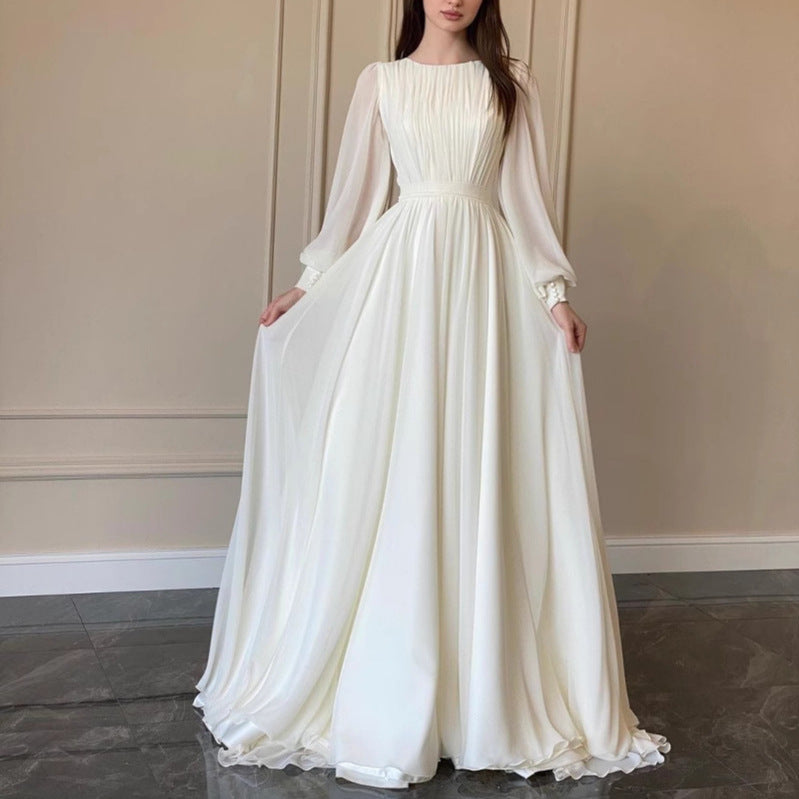 Echoarchiv | Robe de mariée blanche transparente à col rond, manches longues