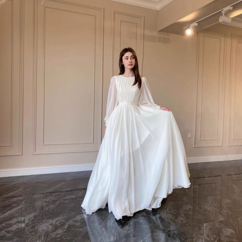 Echoarchiv | Robe de mariée blanche transparente à col rond, manches longues