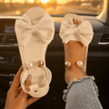 Lunabow – Sandales plates avec nœud et bracelet de cheville en perles